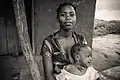 This young Yao mother tries to protect her child through charms worn around the neck