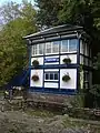 Chesham signal box in 2008, with a sign "CHESHAM" not in the TfL standard Johnston typeface