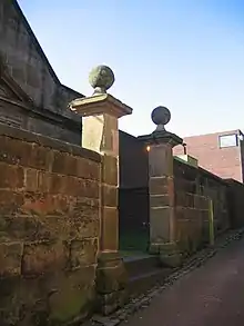 A pair of stone gate piers with ball finials