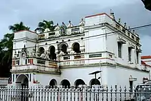 A large two-storey building with white decorated facade