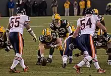 Packers and Bears players lining up prior to the snap of the football to quarterback Aaron Rodgers