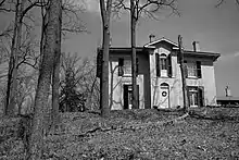 Black and white exterior view of Chiefswood and surrounding trees