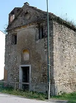 Brown stone church is badly damaged and undecorated.