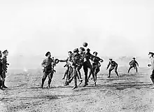 B&W photo of British soldiers playing football