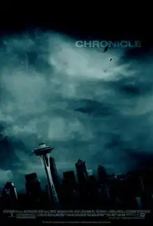 In front of a cloudy sky, three silhouettes of young men float high above Seattle, Washington.