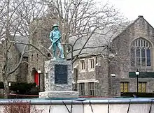 Looking northeast at statue and Community Church of the Circle in Mt. Vernon on a cloudy afternoon