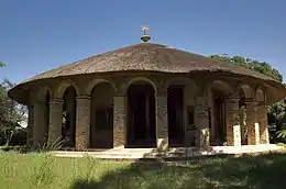 A church with a circular shape with a thatched roof