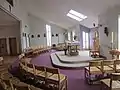 Altar of the Church of Our Lady Roslevan. On the left the shared space with Fahy's Hall (non-carpeted)