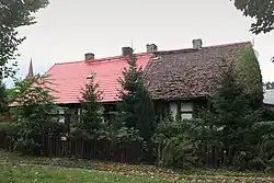 Manor in Chycina, with the spire of the Immaculate Conception church visible to the left of it