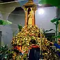 Flowers are placed at the city pillar inside its shrine during the festival (2011 CE)