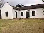 This building was erected in the eighteen-twenties as a dwelling for the Deputy Landdrost.
It is in the Cape Dutch style and TT -shaped.
The building is one of the oldest dwellings in Clanwilliam.
Type of site: House.
Current use: Residential.