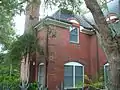 Tudor Revival brick facade and window details