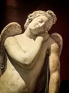 Closeup of Roman statue of Eros, 100–200 CE depicting Eros sleeping,  his torch turned down, a symbol of death used in many Roman memorials.