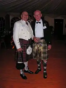 Clan Chief Sir William Macpherson (right) with clan relative Commander Xerxes Z. in white Prince Charlie jacket (left)