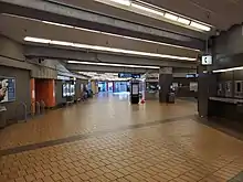 A wide pedestrian tunnel with several exits