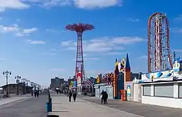 Riegelmann Boardwalk, facing toward the Parachute Jump and Thunderbolt roller coaster, with shops on the right