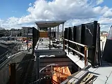 A footbridge to a railway station under construction