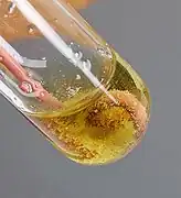 White copper(I) chloride crystals on copper wire