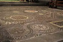 The Cosmati pavement: an elaborately-patterned floor with geometric designs with small red, brown, black and gold tiles