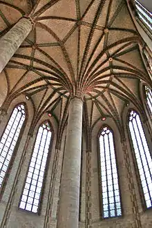 Arched church ceiling, with tall stained-glass windows