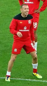 A footballer wearing a red kit