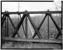 Truss construction with cast-iron diagonal elements in compression and narrow wrought-iron vertical ties in tension