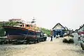 The Cromer Mersey-class Lifeboat "Her Majesty the Queen" (ON1189, temporarily on station during boathouse rebuilding) on the beach at Cromer near the old lifeboat station