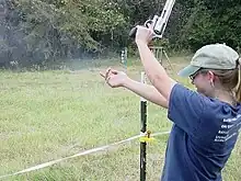 The recoil from the .500 S&W Magnum cartridge inducing significant muzzle rise during firing a Smith & Wesson Model 500 revolver.