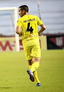 Photograph of the footballer from behind, looking left