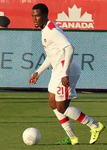 Cyle Larin dribbling a soccer ball.