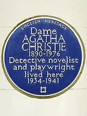 Colour photograph of a wall plaque stating Christie "lived here 1934–1941"