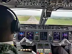 An Embraer 145 on final approach to runway 22