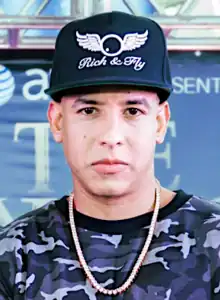 Daddy Yankee wearing sunglasses and holding a microphone