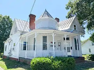 North Danville two-story 1895 frame home built with other identical homes. It has a two-story full-width porch and dual entrances.