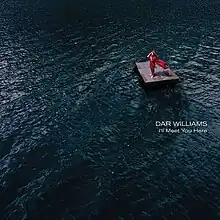 Dar Williams standing on a large raft in water