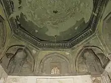 Early example of basic tripartite muqarnas squinches under the dome of the Duvazdah Imam Mausoleum in Yazd (1037–8)