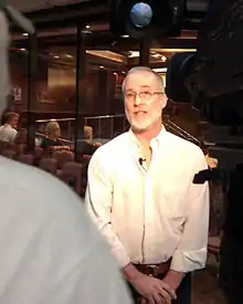 David Nelson speaking with a television-news reporter outside the Salt Lake County Council Chambers at the county adoption of a joint commemorative resolution in 2012