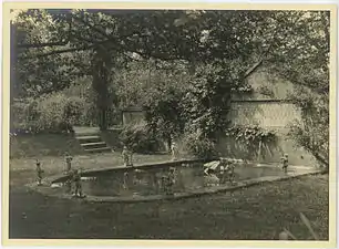 Wall fountain with bronze figurines and Syrian palm tiles.