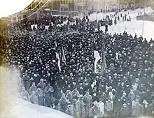 photograph of crowd around flag raising