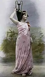 female dancer in classical dress, carrying an amphora