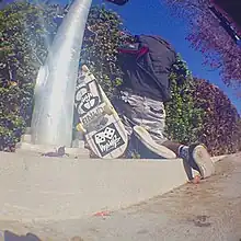 A photo of a man tripping while skateboarding