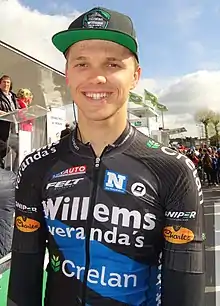 A man in a cycling uniform and suncap