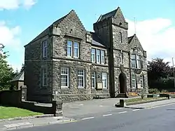 A view of Denny Town House building, with grey brickwork.