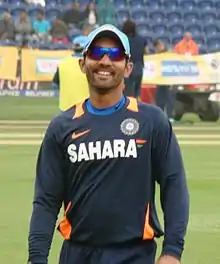 Karthik, smiling, in sunglasses