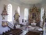 The interior of the churchwith baroque portals and ornate shrines