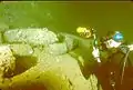 Diver photographing 14-inch artillery shells in the Yamagiri Maru