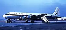 A United Airlines Douglas DC-7 four-prop airliner on an airport tarmac.