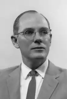 Formal photo of a middle-aged, bespectacled man