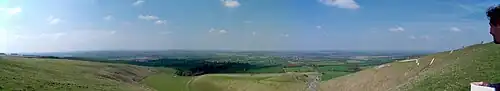 A panoramic view toward Dragon Hill (centre); the White Horse is on the right