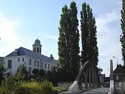 View on Drongen, with the "Oude Abdij" (Old Abbey), the tower of the Church of Saint Gerulph, and the Pontbrug bridge over an arm of the Leie